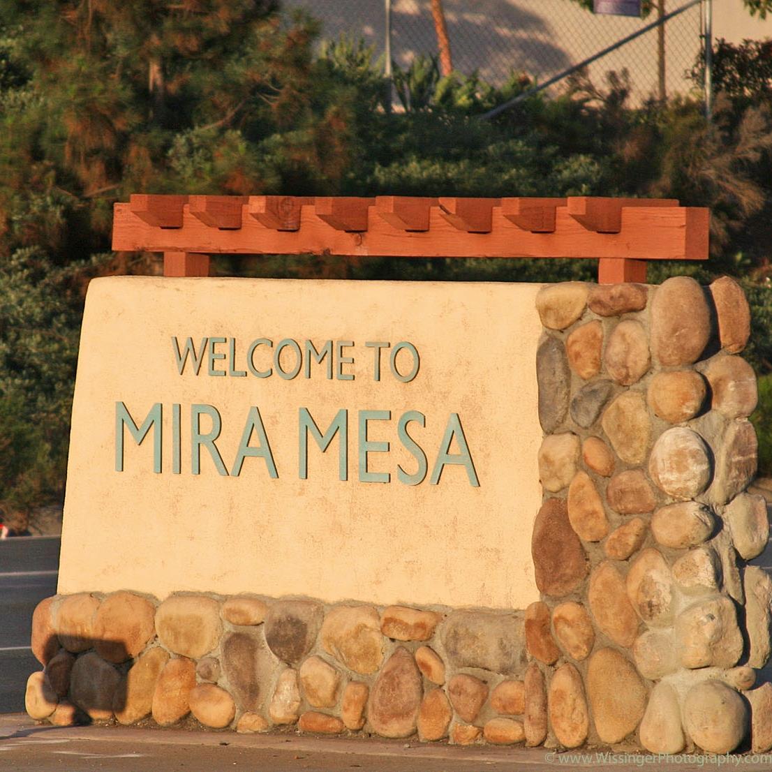 Cleaner wiping kitchen counters and mopping floors in busy Mira Mesa family home