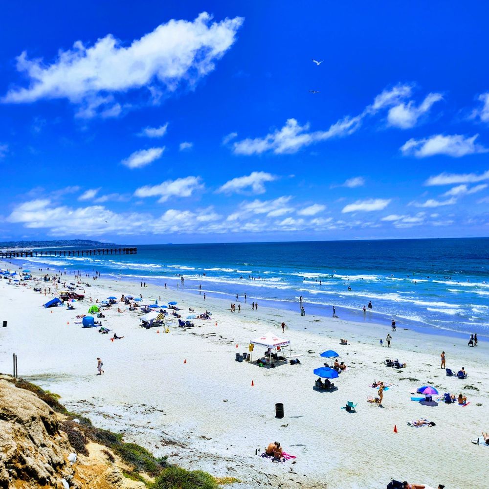 Cleaner refreshing floors and kitchen surfaces in occupied Pacific Beach coastal condo