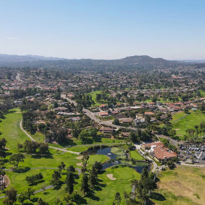 Cleaner wiping kitchen counters in occupied Rancho Bernardo family home